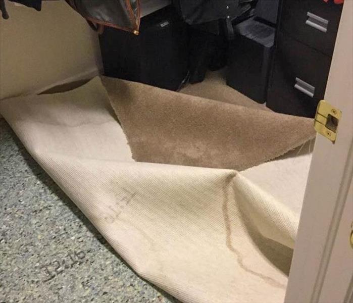 Carpet pulled back in a closet
